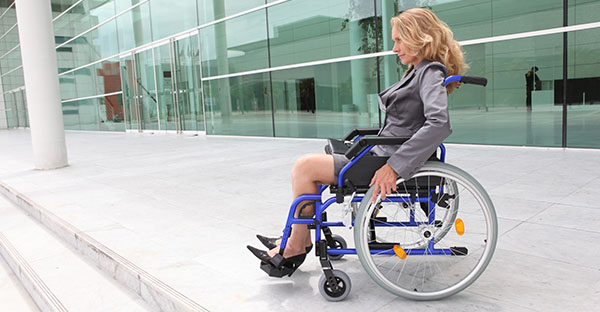 Woman in a wheelchair outside an office building